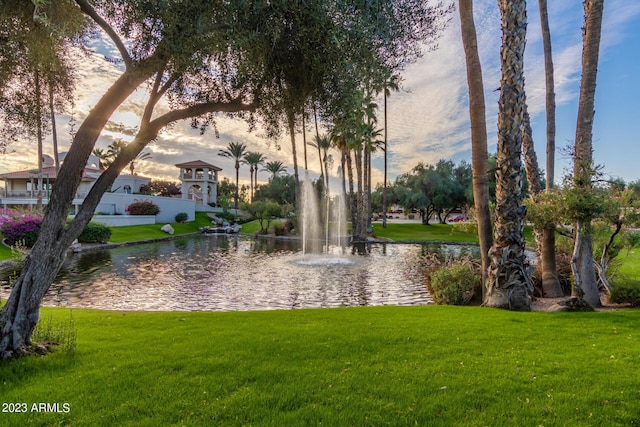 surrounding community featuring a water view and a yard