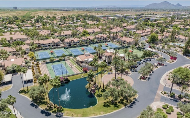 drone / aerial view with a water and mountain view