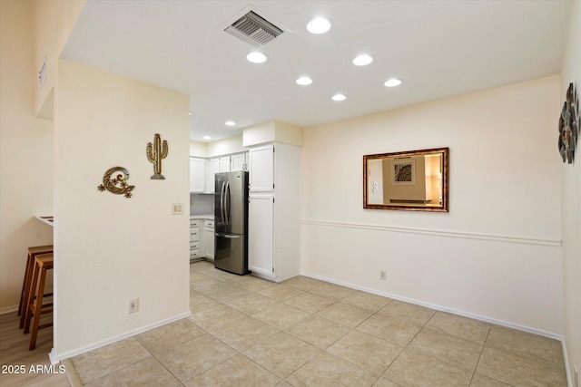 unfurnished room featuring light tile patterned floors