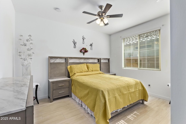 bedroom with ceiling fan and light hardwood / wood-style floors