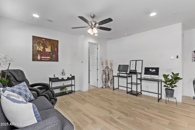 living room featuring ceiling fan and light hardwood / wood-style floors