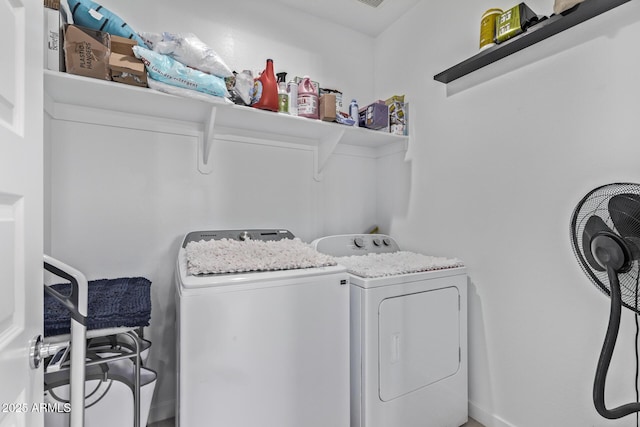 laundry room featuring washing machine and clothes dryer