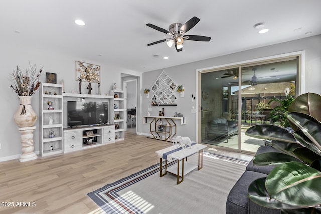 living room featuring hardwood / wood-style flooring and ceiling fan