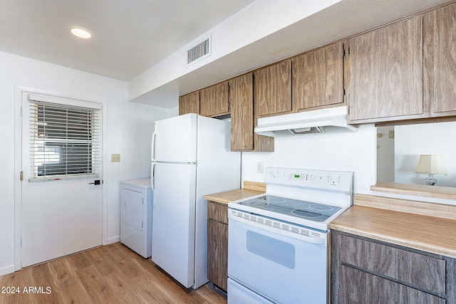 kitchen featuring light countertops, visible vents, white appliances, washer / clothes dryer, and under cabinet range hood