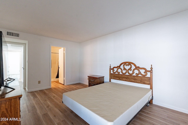 bedroom with hardwood / wood-style flooring