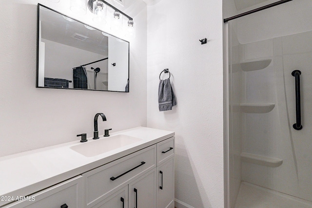 bathroom featuring a shower with curtain, vanity, and visible vents