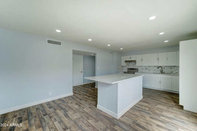 kitchen featuring light hardwood / wood-style flooring, sink, a center island, electric range, and white cabinets