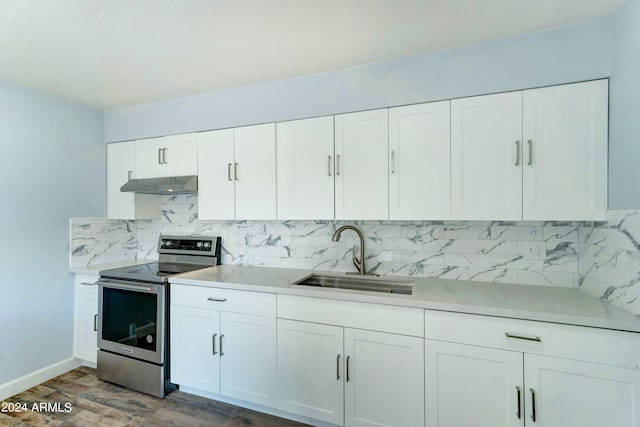 kitchen with dark hardwood / wood-style floors, extractor fan, sink, electric range, and white cabinetry