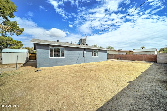 back of property with a storage unit