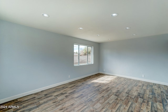 empty room with hardwood / wood-style flooring