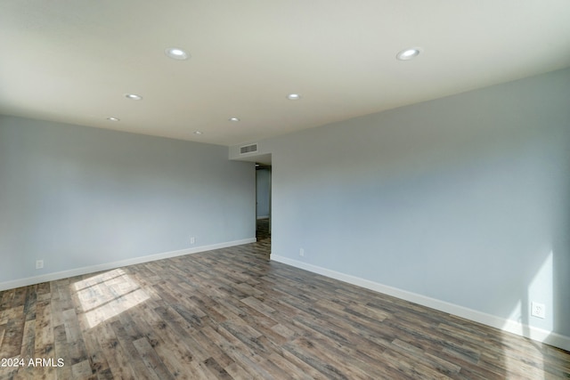 unfurnished room featuring dark wood-type flooring