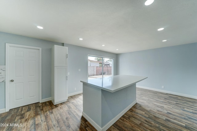 kitchen featuring a center island, white cabinets, and dark hardwood / wood-style flooring