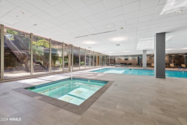 view of pool with an indoor in ground hot tub and a patio area