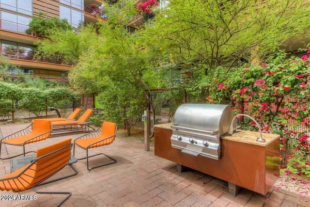 view of patio / terrace featuring exterior kitchen and grilling area