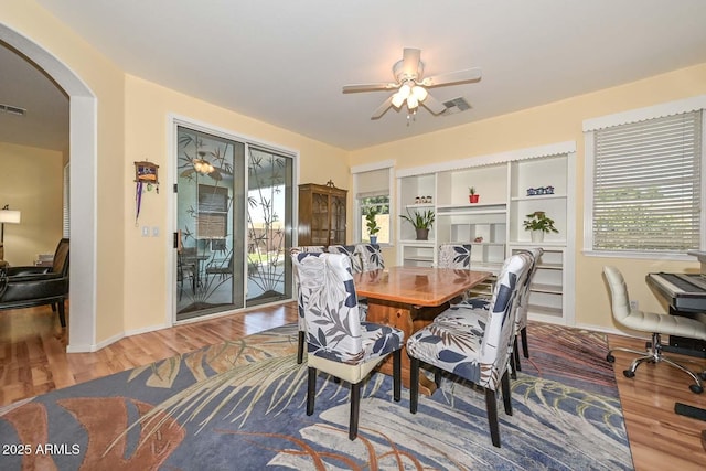 11580 N 86th Ln, Peoria, AZ 85345 - dining room with wood finished floors, plenty of natural light, arched walkways, and a ceiling fan