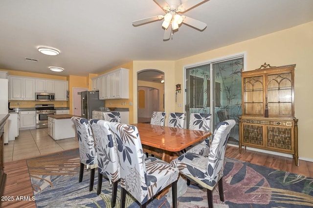 11580 N 86th Ln, Peoria, AZ 85345 - dining area featuring arched walkways, ceiling fan, and light wood-style floors