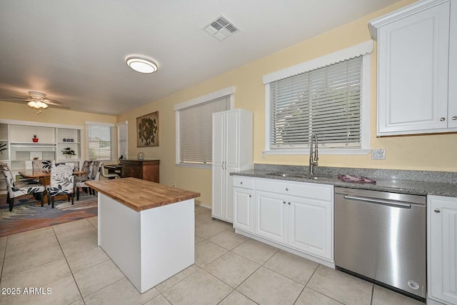 11580 N 86th Ln, Peoria, AZ 85345 - kitchen featuring dishwasher, butcher block counters, light tile patterned flooring, and white cabinetry