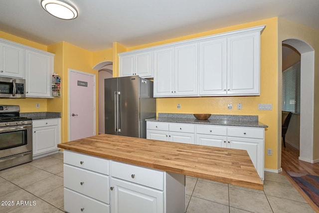 11580 N 86th Ln, Peoria, AZ 85345 - kitchen with appliances with stainless steel finishes, arched walkways, wood counters, and white cabinets
