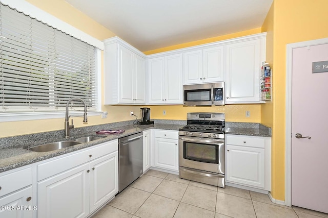 11580 N 86th Ln, Peoria, AZ 85345 - kitchen with stainless steel appliances, white cabinetry, and light tile patterned floors