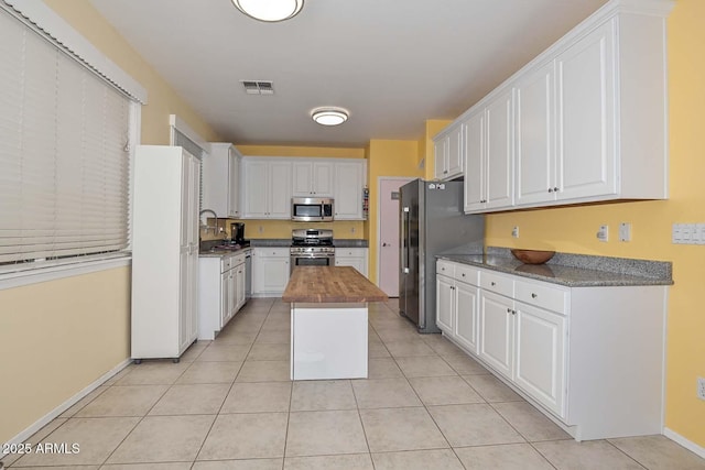 11580 N 86th Ln, Peoria, AZ 85345 - kitchen featuring appliances with stainless steel finishes, white cabinetry, and butcher block countertops