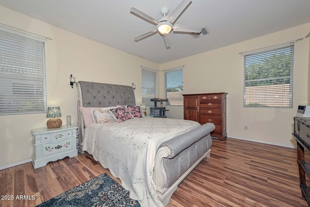 11580 N 86th Ln, Peoria, AZ 85345 - bedroom featuring wood finished floors, multiple windows, and ceiling fan
