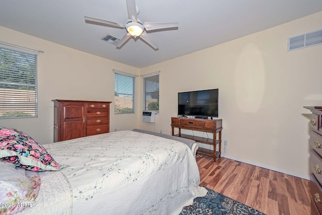 11580 N 86th Ln, Peoria, AZ 85345 - bedroom with wood finished floors, a ceiling fan, and cooling unit