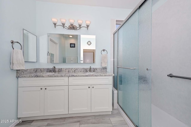 11580 N 86th Ln, Peoria, AZ 85345 - bathroom featuring a shower with door and double vanity