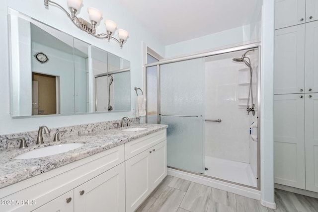 11580 N 86th Ln, Peoria, AZ 85345 - bathroom featuring a shower stall and double vanity