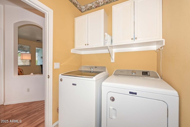 11580 N 86th Ln, Peoria, AZ 85345 - laundry room with washer and dryer, cabinet space, and wood finished floors