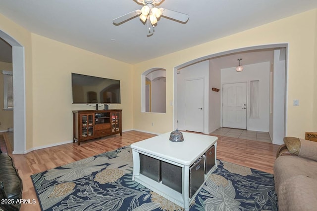 11580 N 86th Ln, Peoria, AZ 85345 - living area with arched walkways, light wood-style flooring, and a ceiling fan