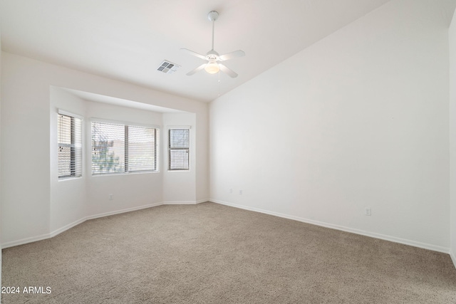 empty room with carpet flooring, ceiling fan, and vaulted ceiling