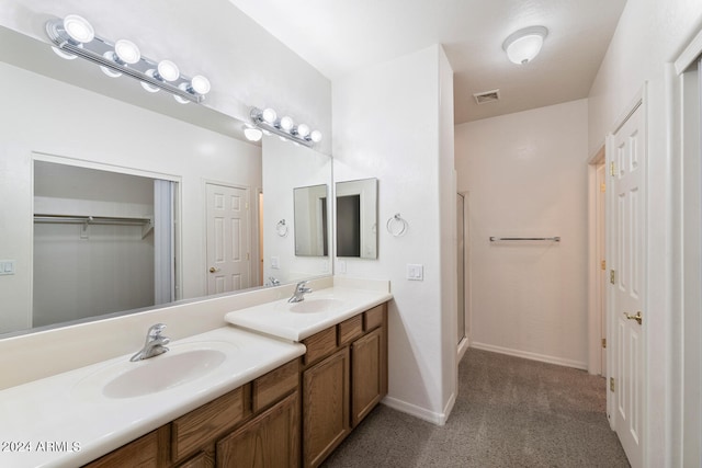 bathroom with vanity and a shower with door