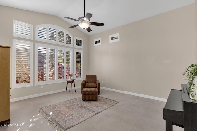 living area with light tile patterned floors and ceiling fan