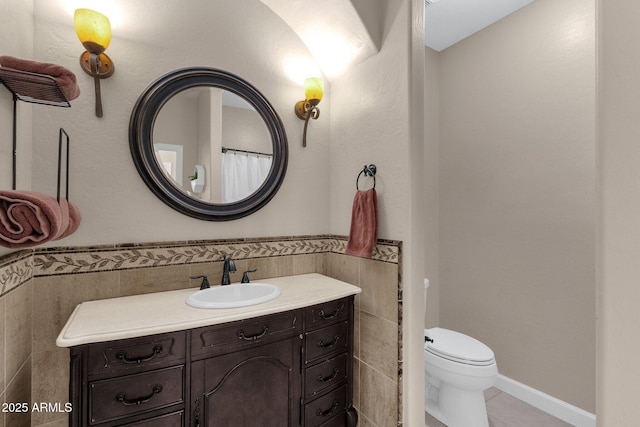 bathroom with toilet, tile patterned floors, and vanity