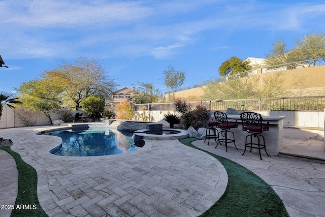 view of swimming pool featuring an in ground hot tub, a patio, and exterior bar