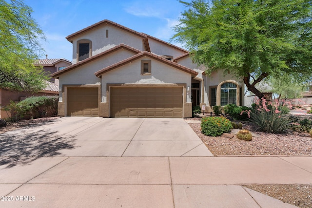35746 N 32nd Ln, Phoenix, AZ 85086 - mediterranean / spanish house with stucco siding, driveway, a tile roof, and a garage