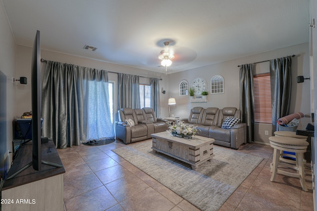 living room with ceiling fan and tile patterned floors