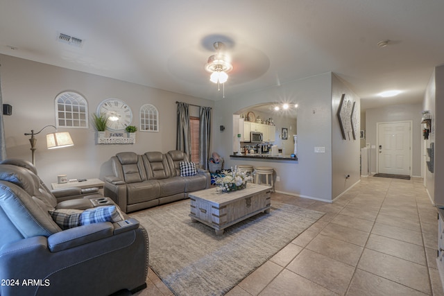 tiled living room with ceiling fan