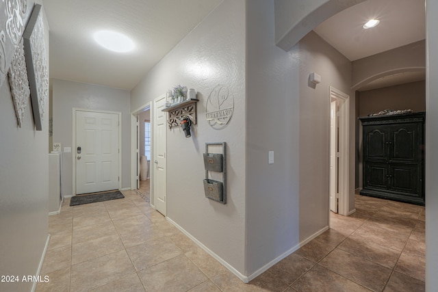 corridor featuring light tile patterned floors