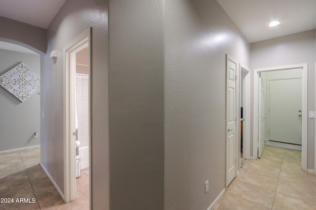 corridor featuring light tile patterned floors