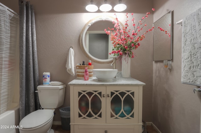 full bathroom with toilet, shower / bathtub combination with curtain, and vanity