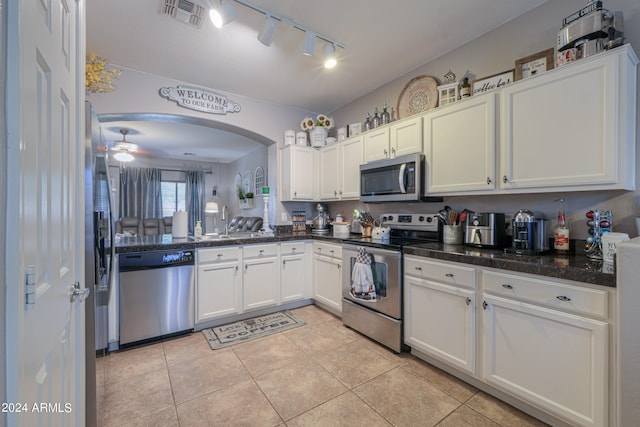 kitchen featuring appliances with stainless steel finishes, ceiling fan, light tile patterned floors, and white cabinets