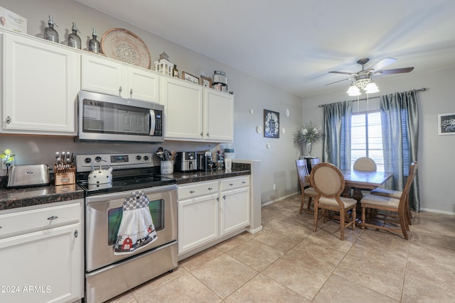 kitchen with white cabinets, appliances with stainless steel finishes, light tile patterned floors, and ceiling fan