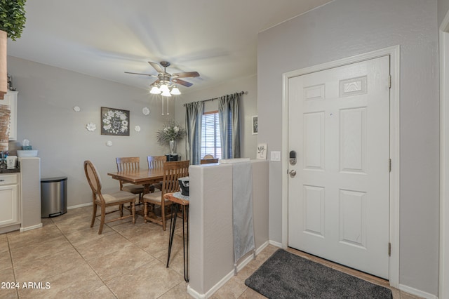 interior space with light tile patterned floors and ceiling fan