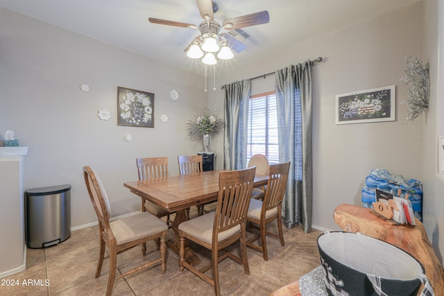 tiled dining area with ceiling fan