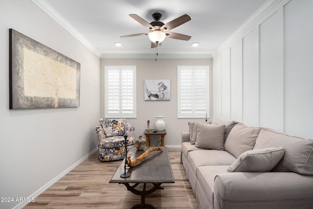 living room with light hardwood / wood-style floors, ornamental molding, and ceiling fan