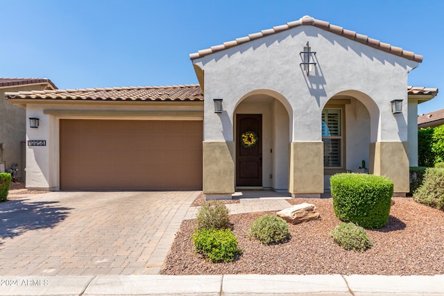 mediterranean / spanish-style house with a garage