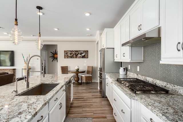 kitchen featuring pendant lighting, sink, white cabinetry, appliances with stainless steel finishes, and dark hardwood / wood-style flooring