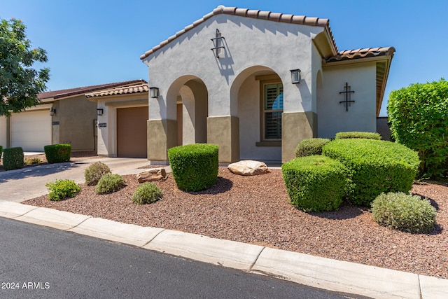 mediterranean / spanish-style home featuring a garage