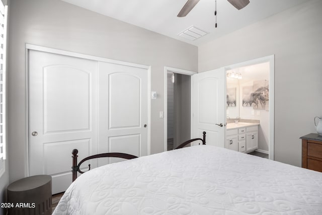 bedroom featuring ceiling fan, a closet, and ensuite bath